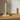 Tacana lysestage i grøn fra Bloomingville – med tændt lys på spisebord